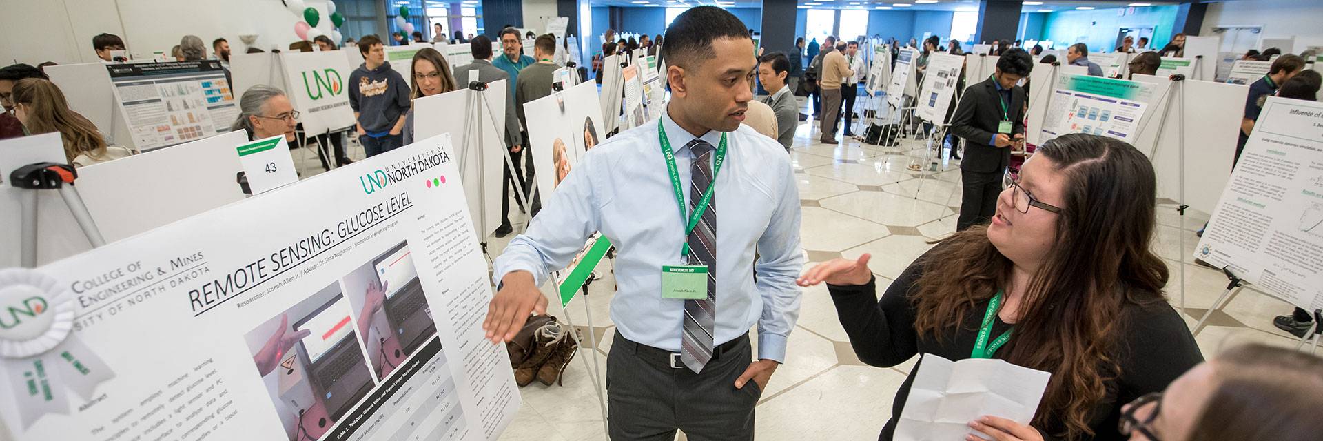 Student presenting at a conference poster session