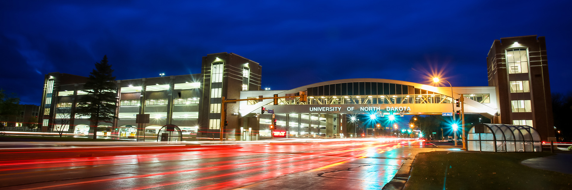 Timelapse of taillights traveling under the University of North Dakota parking ramp walkway.