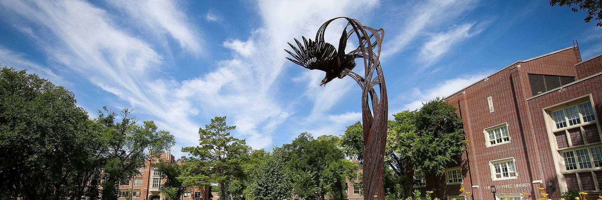 Soaring Eagle sculpture under a summer sky on UND's campus.