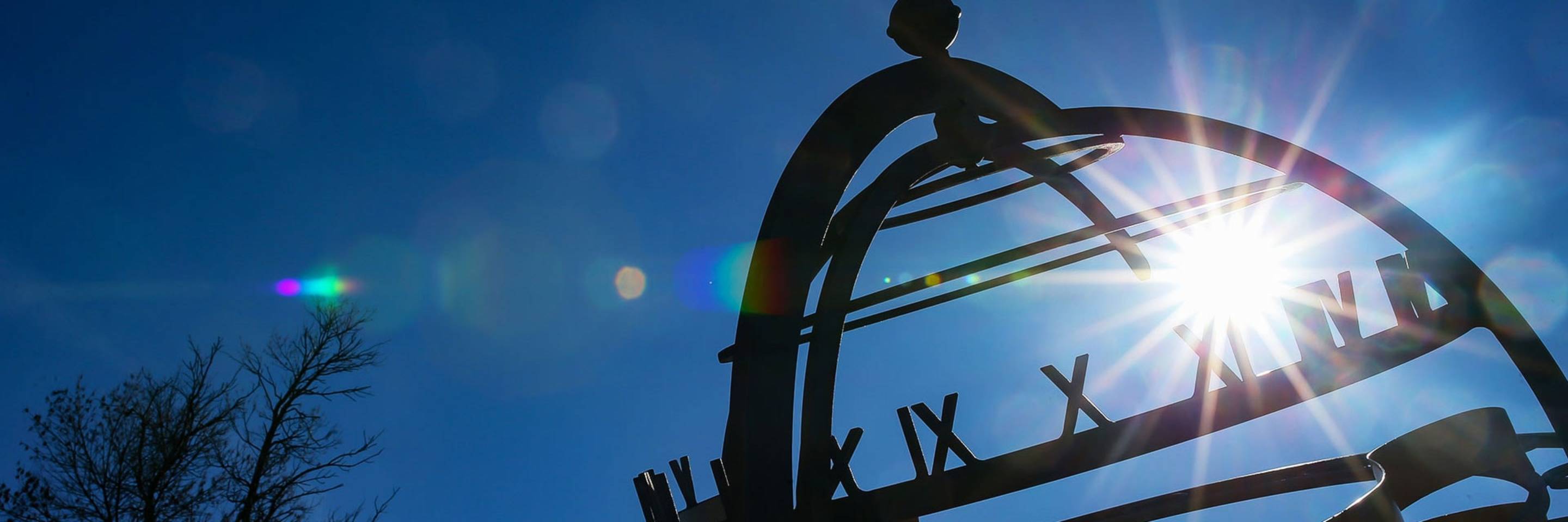 Sun shining through a sculpture on the University of North Dakota campus.