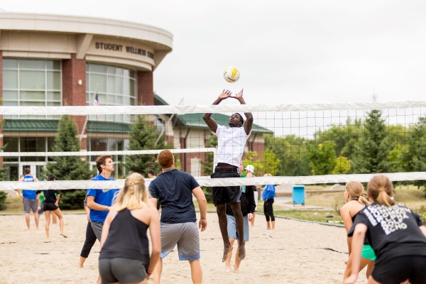 Students playing sand volleyball