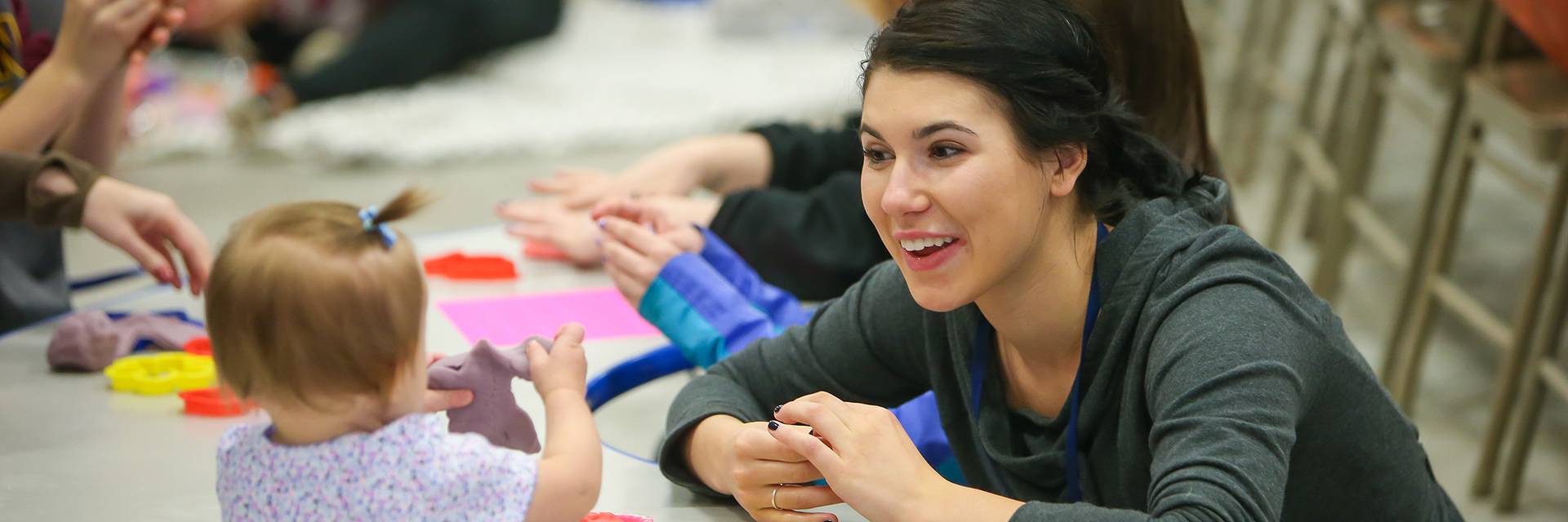 student reading camp student with children