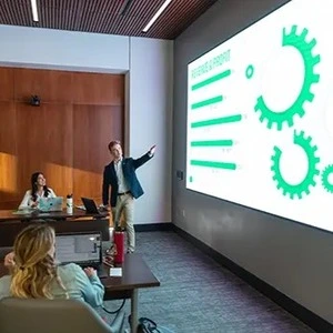 A business student delivering a presentation in a classroom.