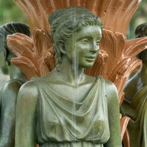 A statue depicting a woman's face, part of the Adelphi fountain at UND.