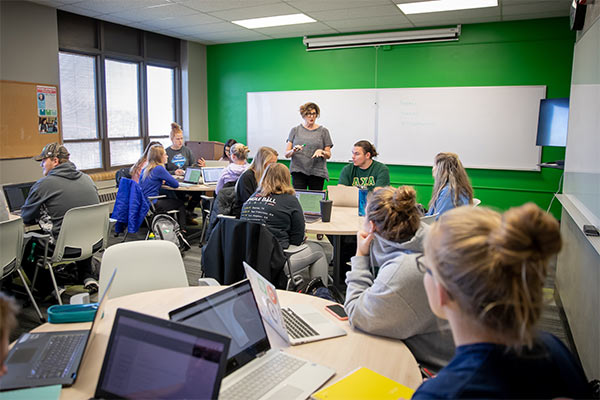 students in classroom with a faculty member