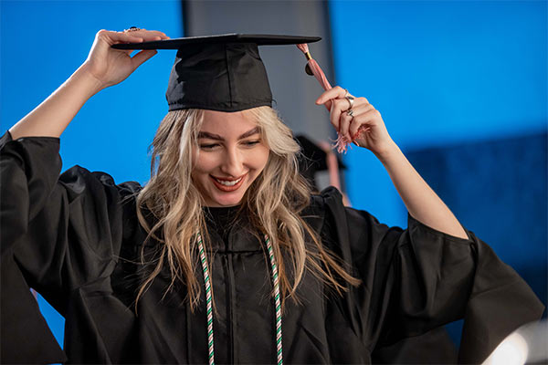 student in cap and gown at graduation