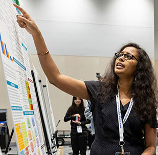 Student standing at a presentation board.