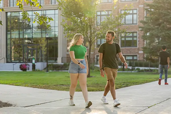 Two students walking in UND quad