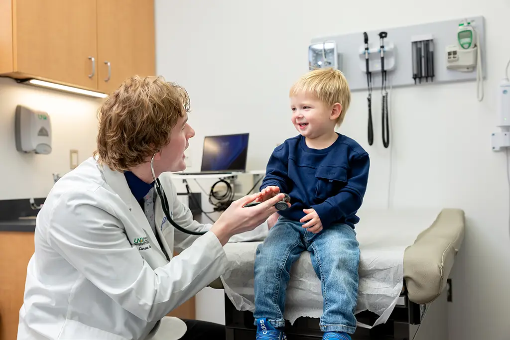 carson working with small child in clinic