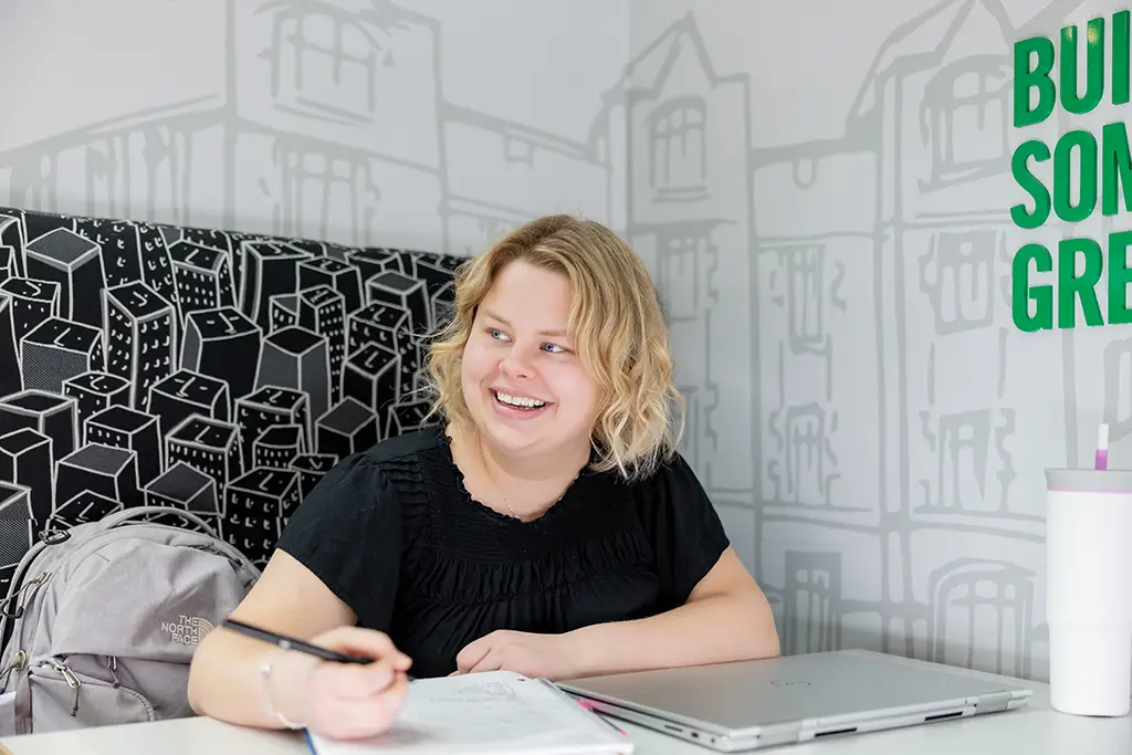 Two women running on campus