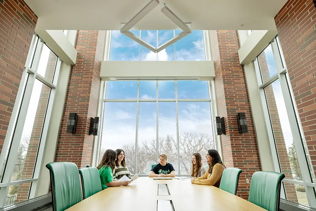 Julia at study table with two friends