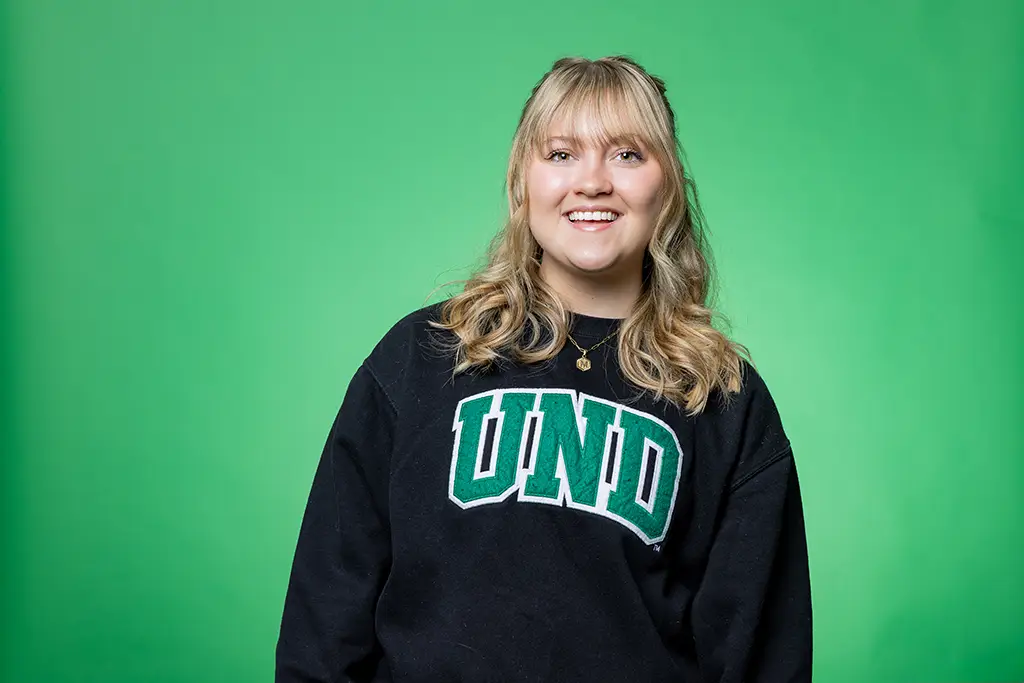 photo of Madilyn Lee in front of green screen