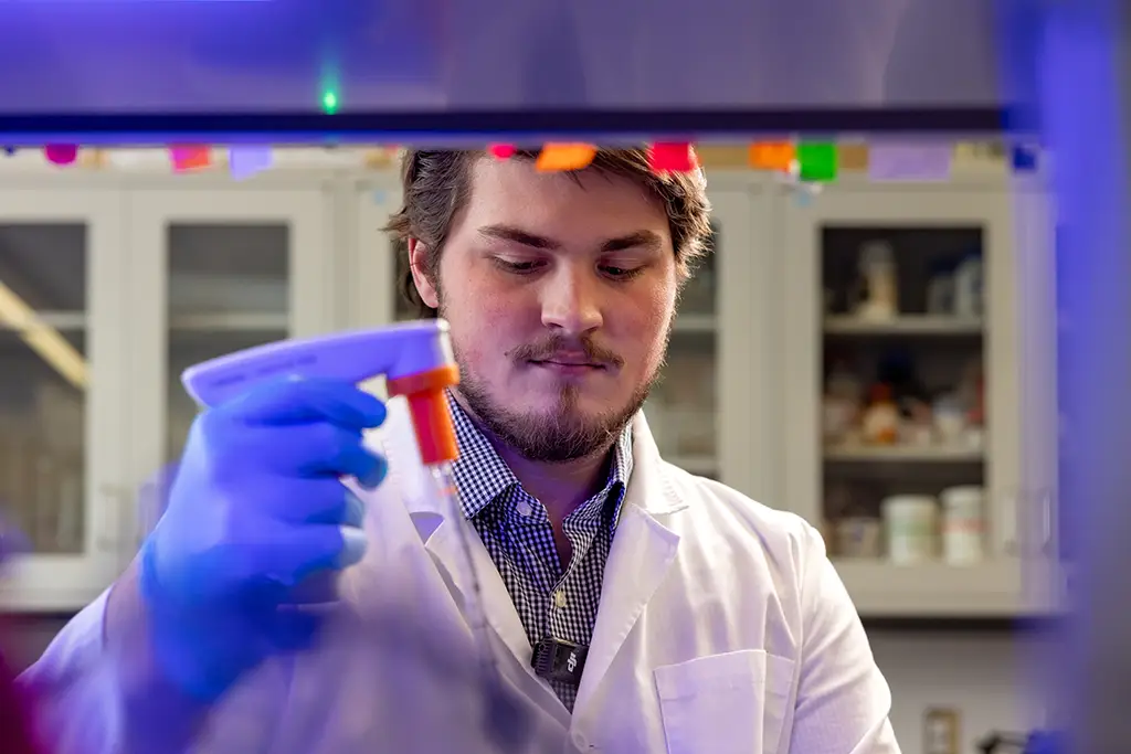 Mason Curtis working in UND labratory