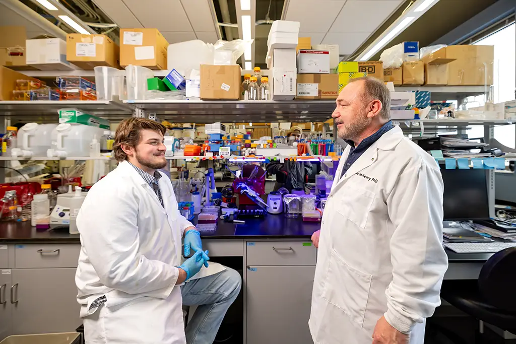 mason in lab coat in research facility