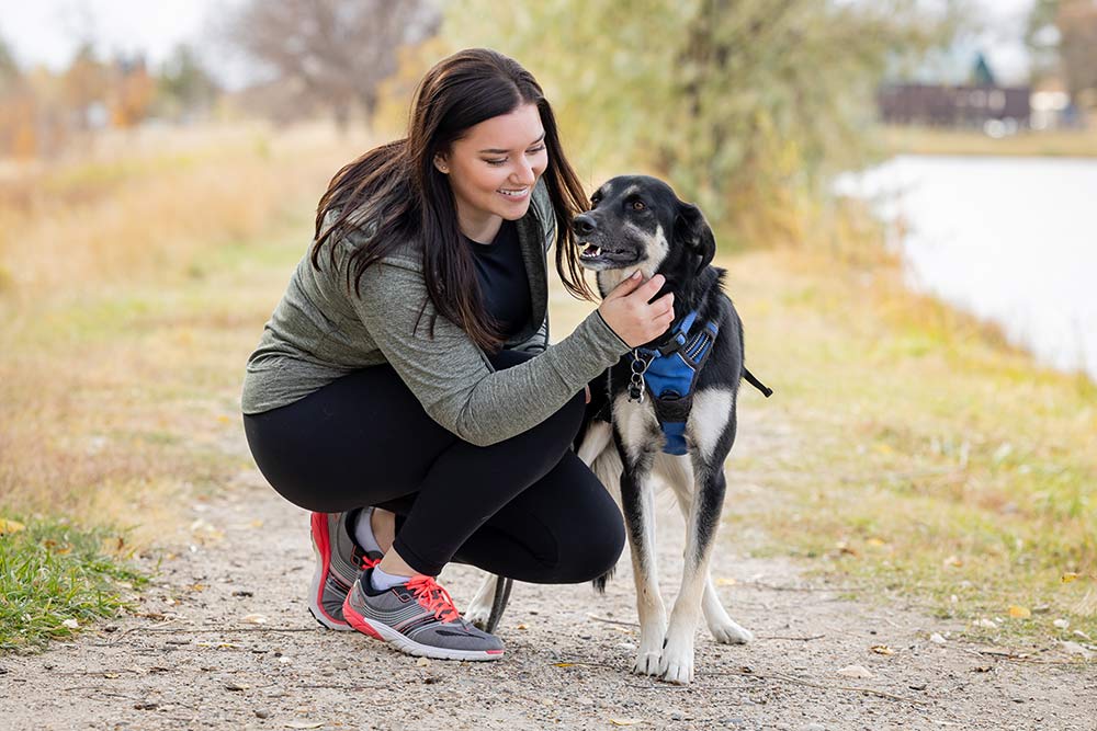 Mckenzie Moe walking outside with her dog