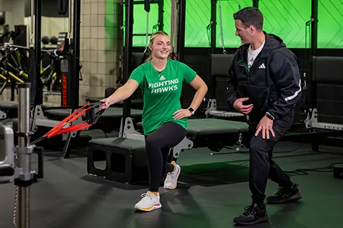 Renee Temple working out with UND cheer coach