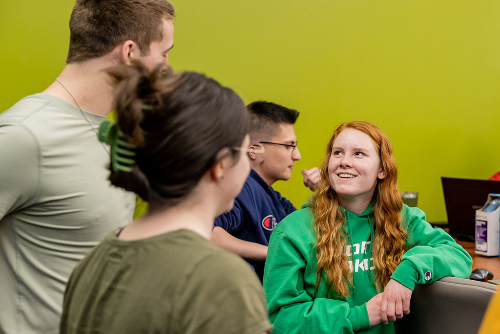 sydney smiling with friends in engineering lab
