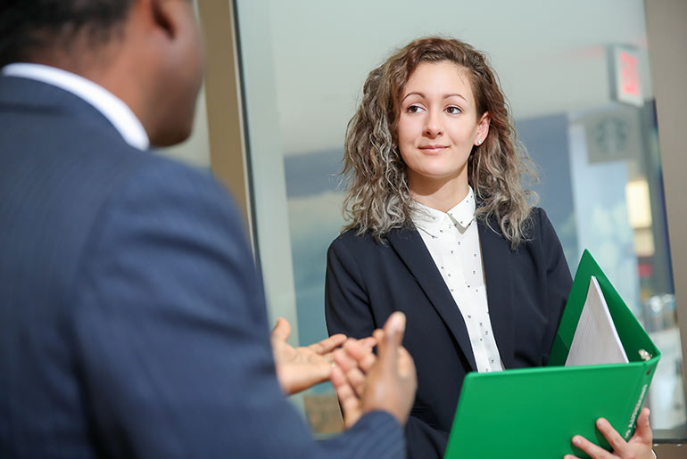 Zsofia Barandi with a green binder