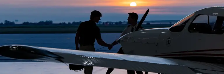 UND Commercial Aviation Degree Student in Front of Plane