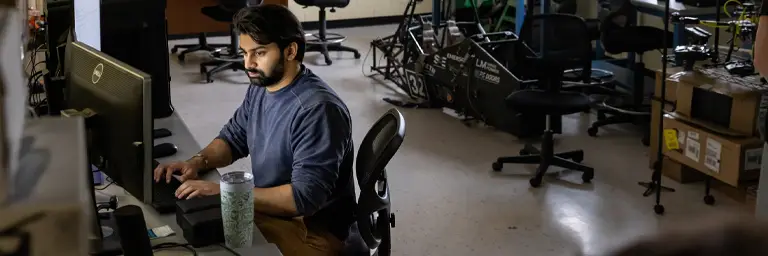 UND Computer Science Masters Degree Student Working at Computer