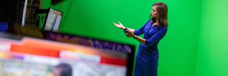 digital production student in front of TV camera