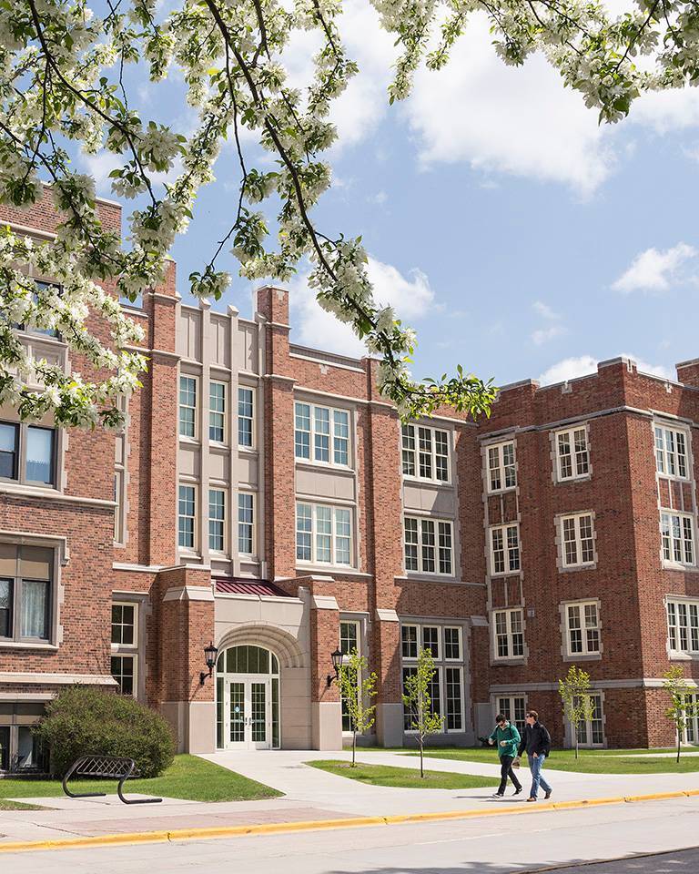 Teacher helping young student write