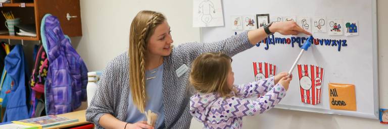 early childhood education degree student with small child