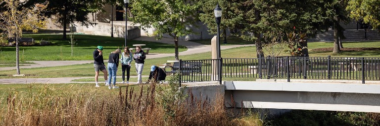 environmental studies students doing class project outdoors