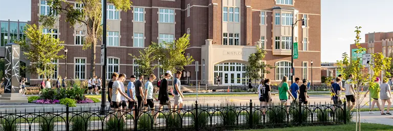 students walking by business college
