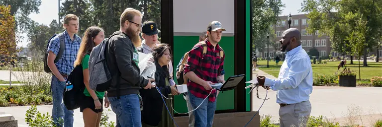 UND Geography Students Working on Class Project Outdoors on Campus