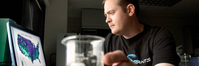 geography student looking at map on computer