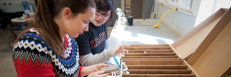 geological engineering students looking at rock samples