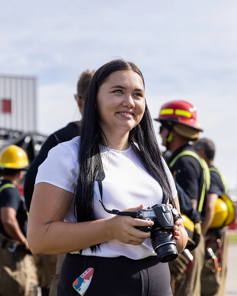 journalism student with camera taking pictures