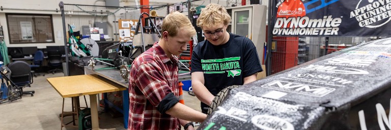 mechanical engineering students working on car