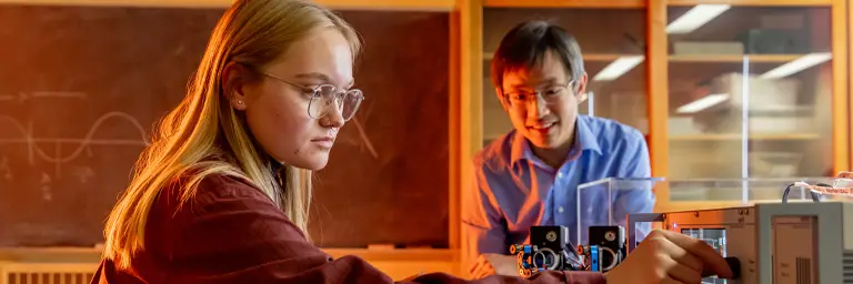 UND Physics Student Working with Professor in Classroom