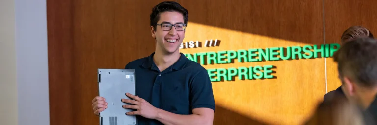 Student smiling in Entrepreneurship & Communication class