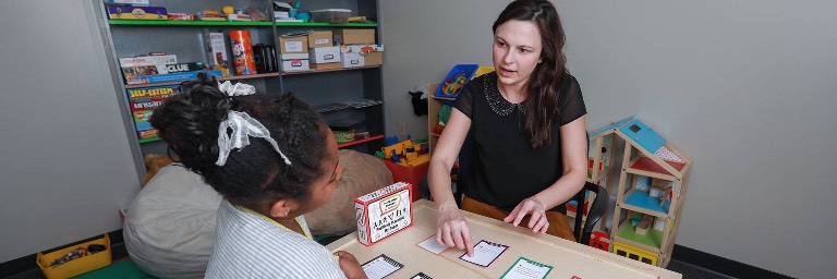 psychology degree student working with child in session