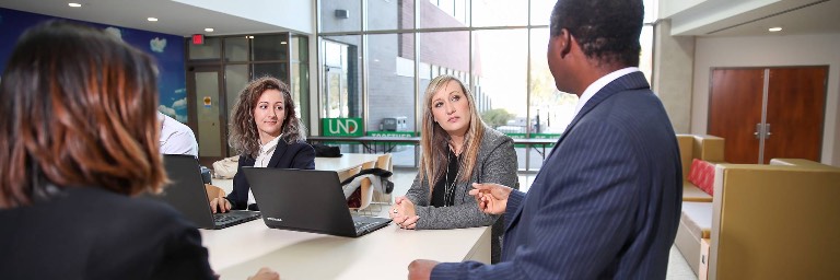 public administration students listening at group table
