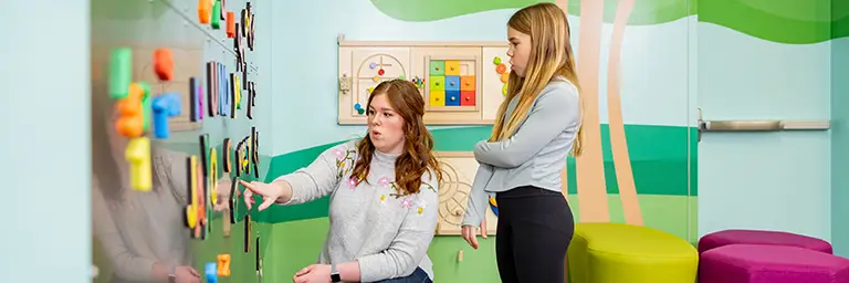 teacher engaging with young student