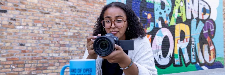 Social Media Strategy student taking picture in Downtown Grand Forks