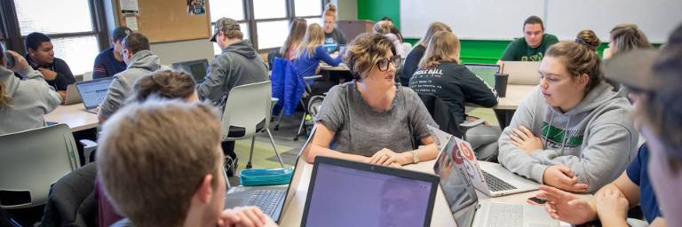 spanish professor with students at table