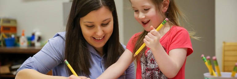 Teacher working with young student