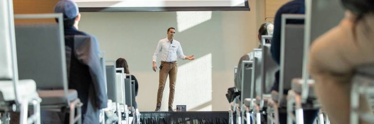 communication student speaking on stage