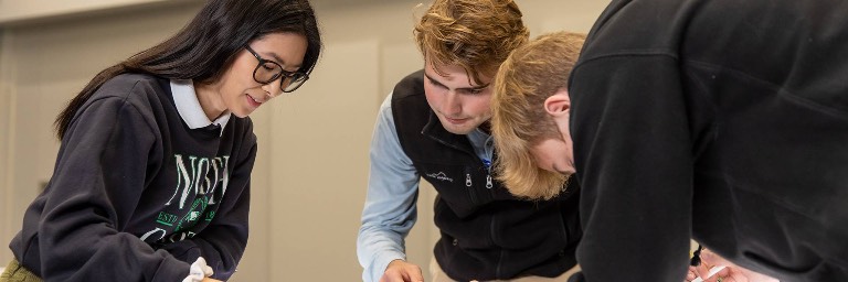 Teacher helping student in classroom