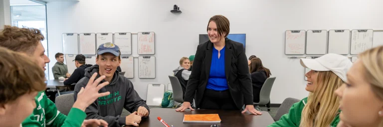 instructor with students having a discussion