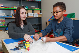 Adult working with child.