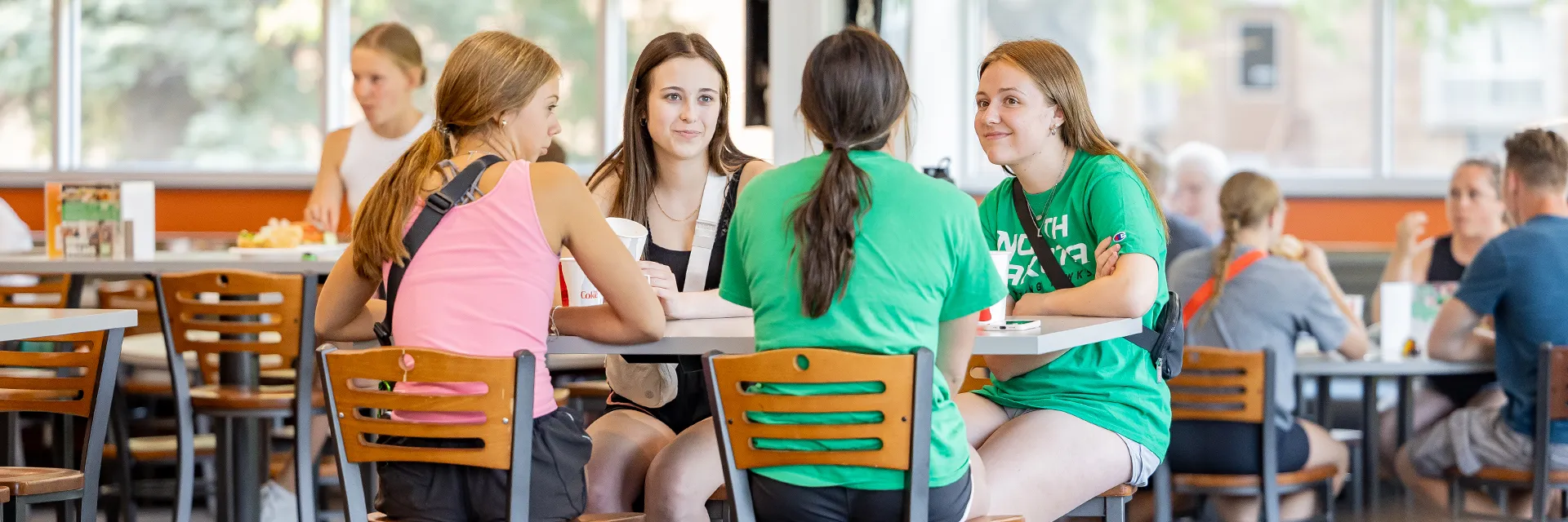 group of four female students in dining center at table