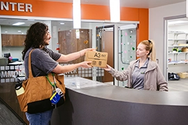Student picks up a package at the service counter