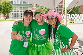 three smiling resident assistants pose for a photo